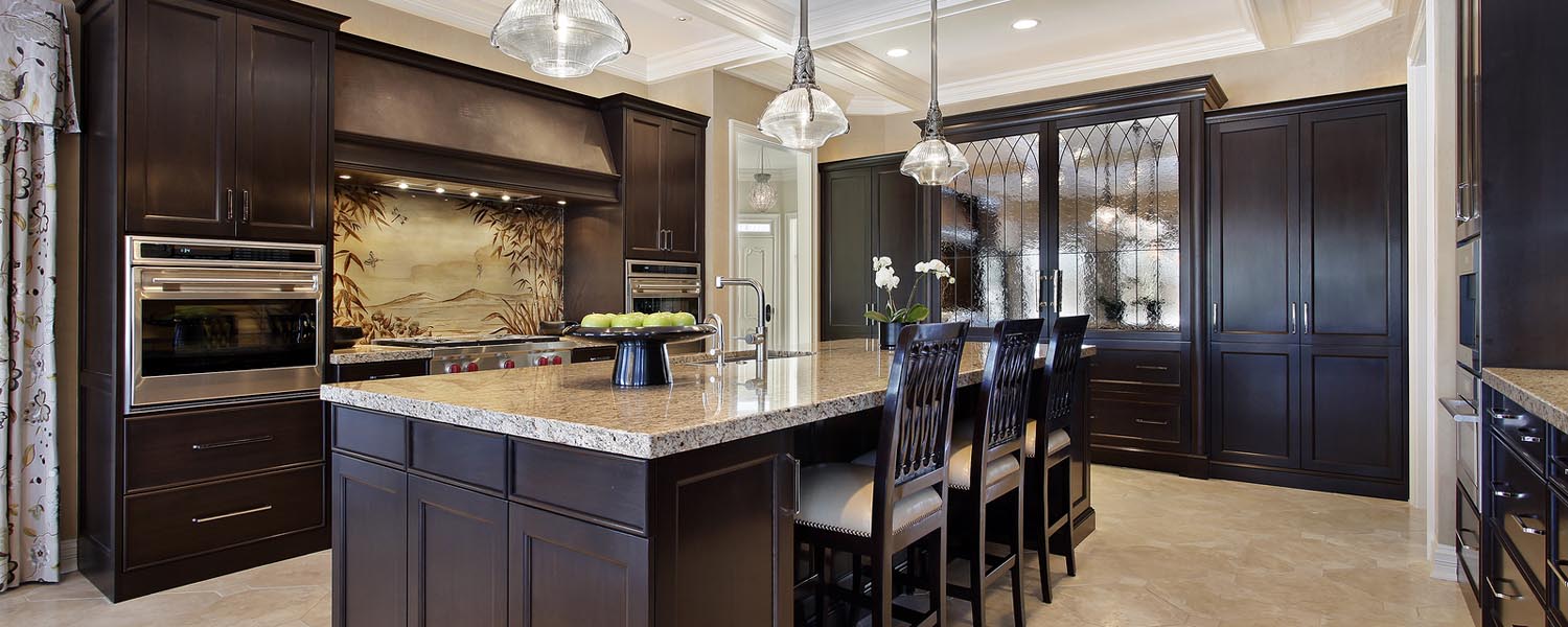 Luxury kitchen in upscale home with dark wood cabinetry